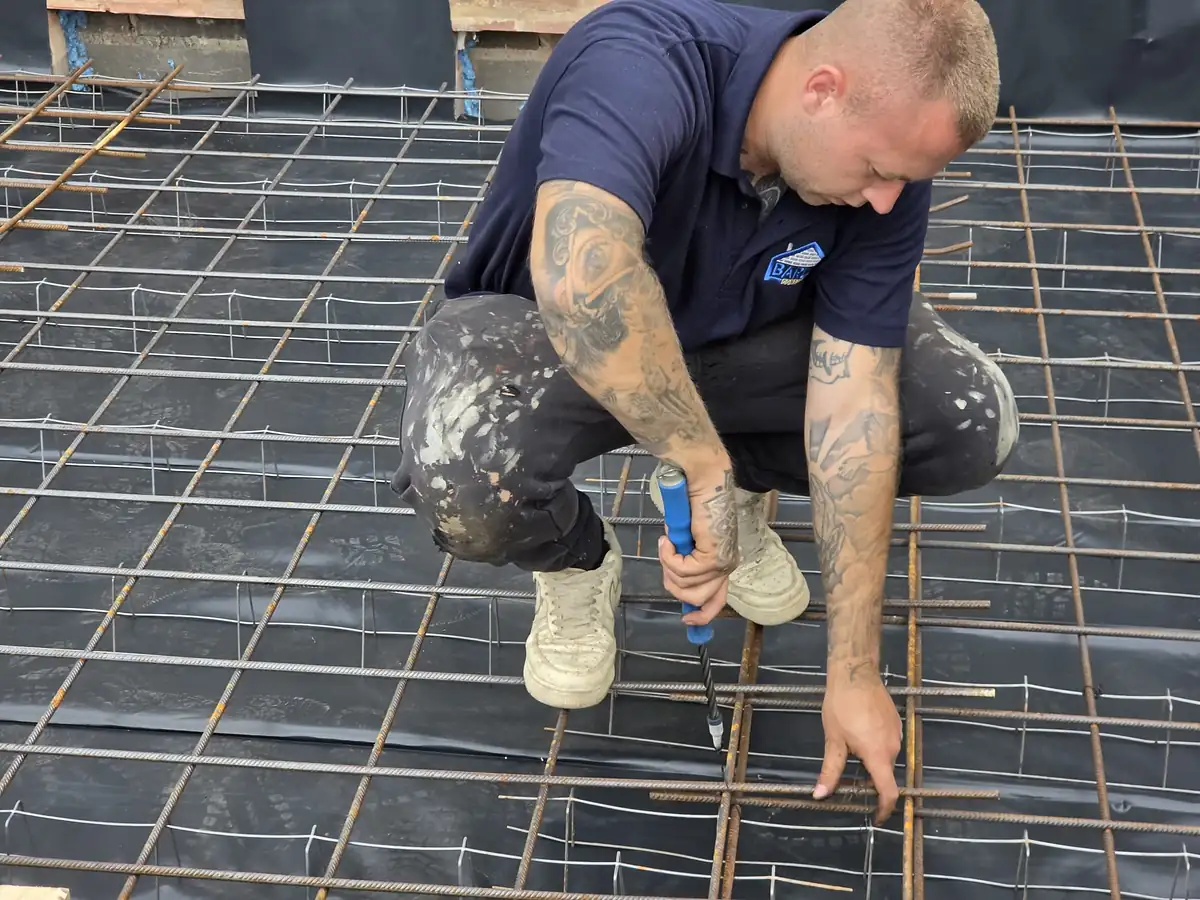 Barlow team member fixing steel reinforcement mesh