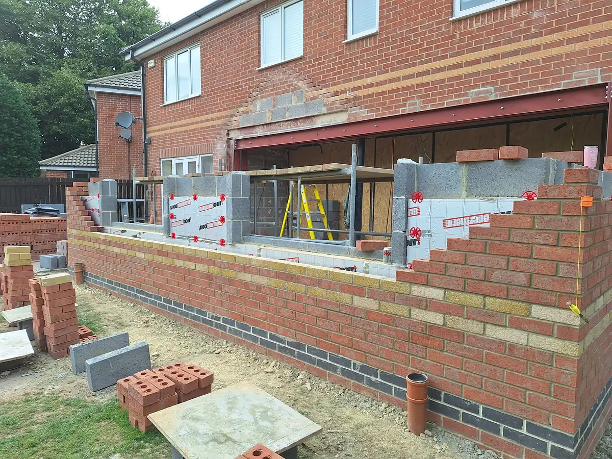 Brick and block walls up to roof level