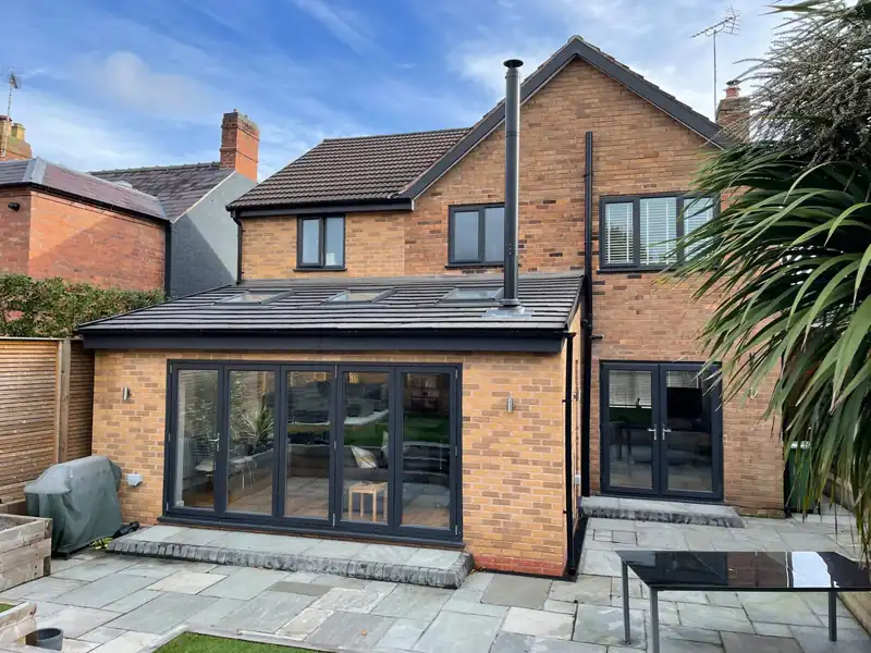 Brick rear extension with bifold doors and sandstone patio
