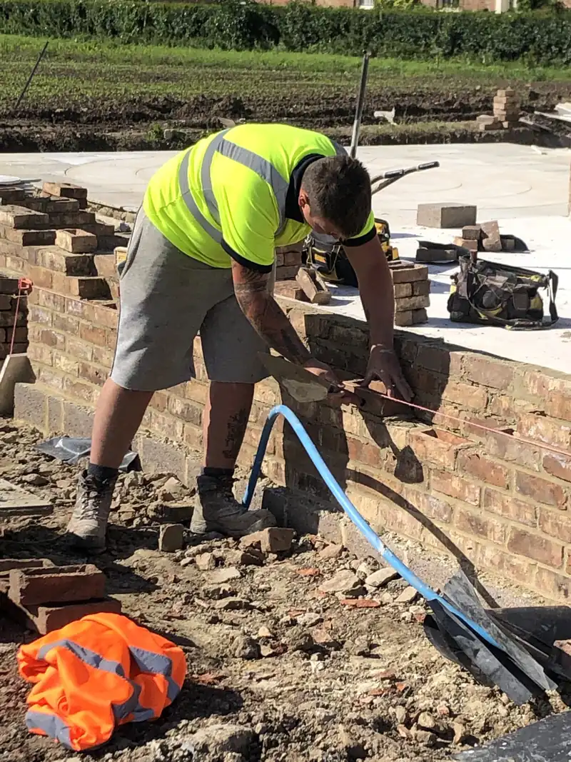 Bricklayer building a garden wall