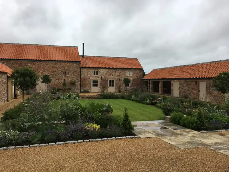 Converted pantile barns around a courtyard garden