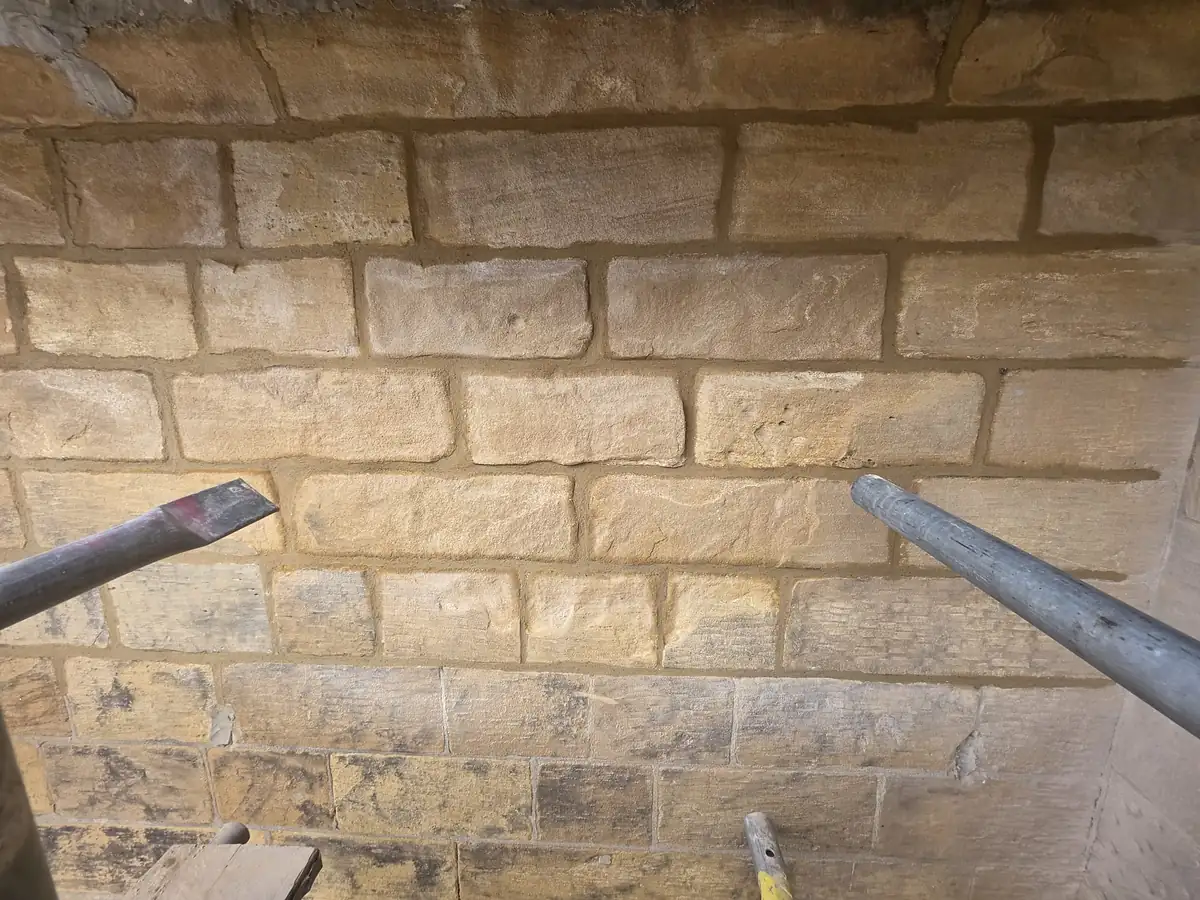 Coursed stone wall after repointing