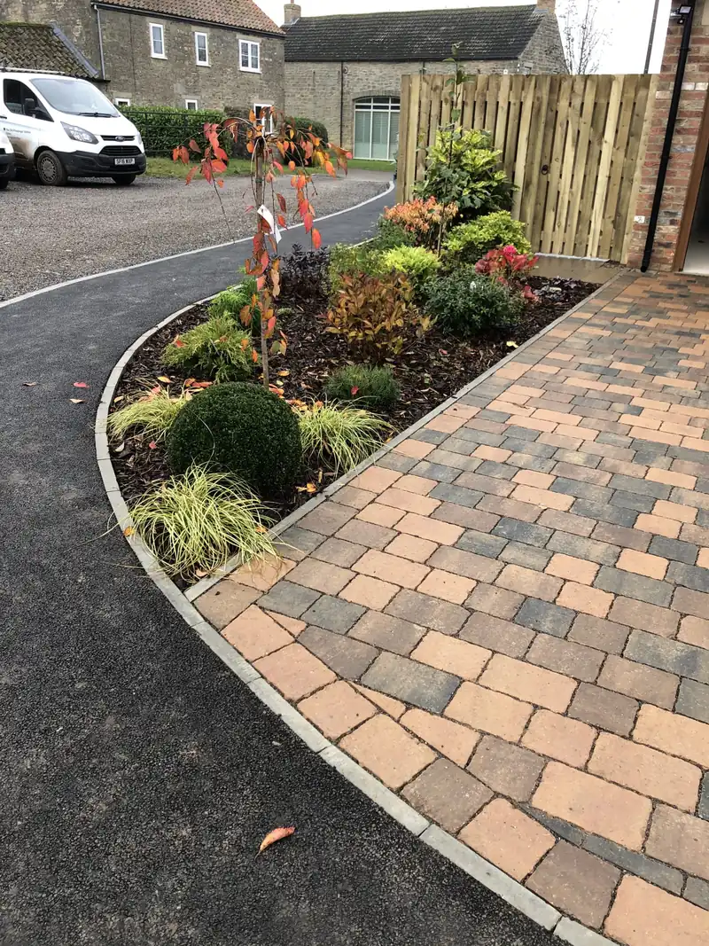 Curved block paved path with planting