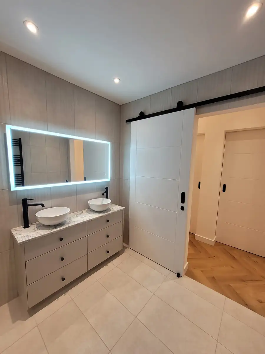 Double vanity with a lit mirror