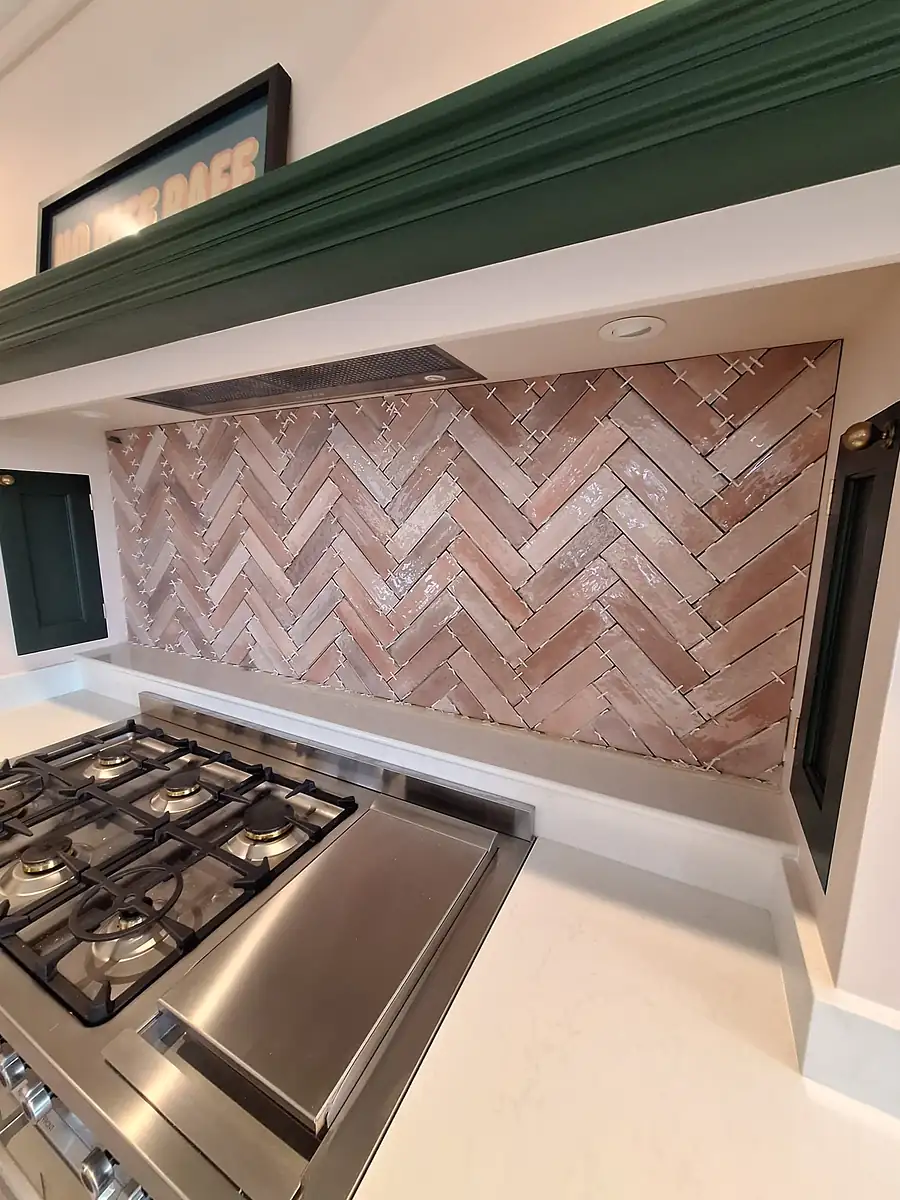 Herringbone brick splashback behind a range cooker