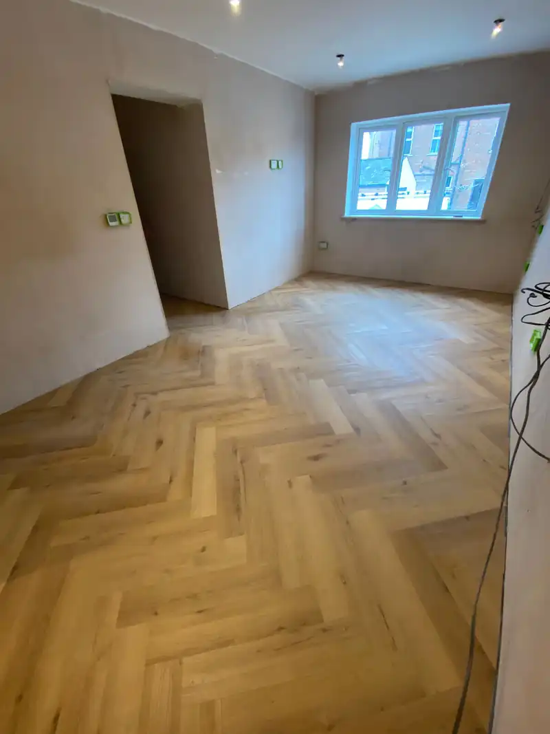 Renovated room with a herringbone floor