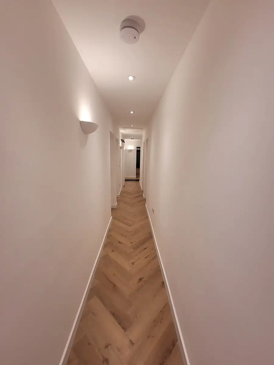 Long hallway with herringbone floor