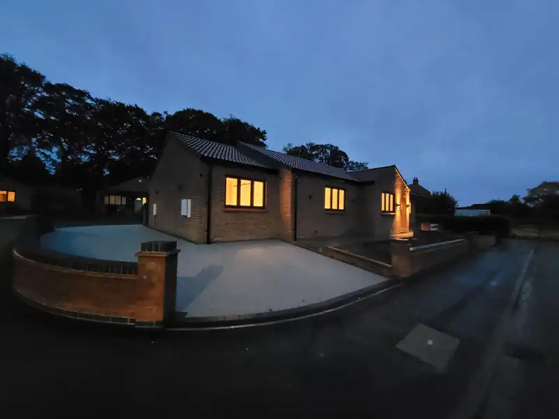 Mallorie Court lit at dusk from the drive