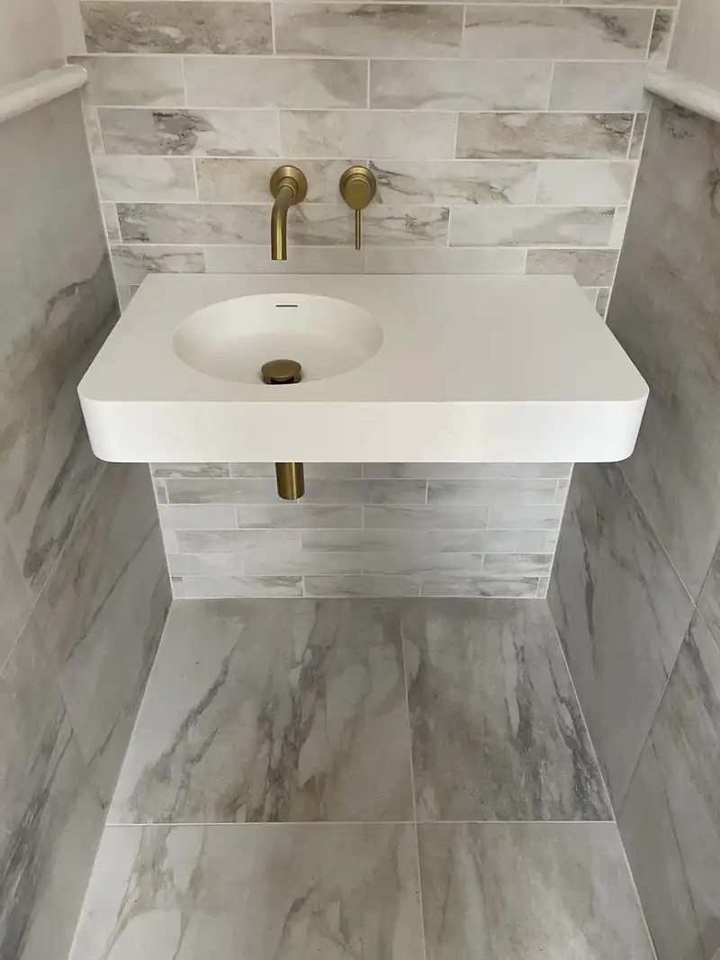 Marble effect tiles and wall hung basin