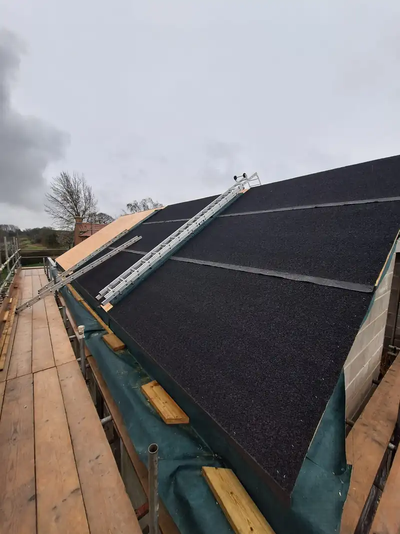 New slate roof being laid over membrane