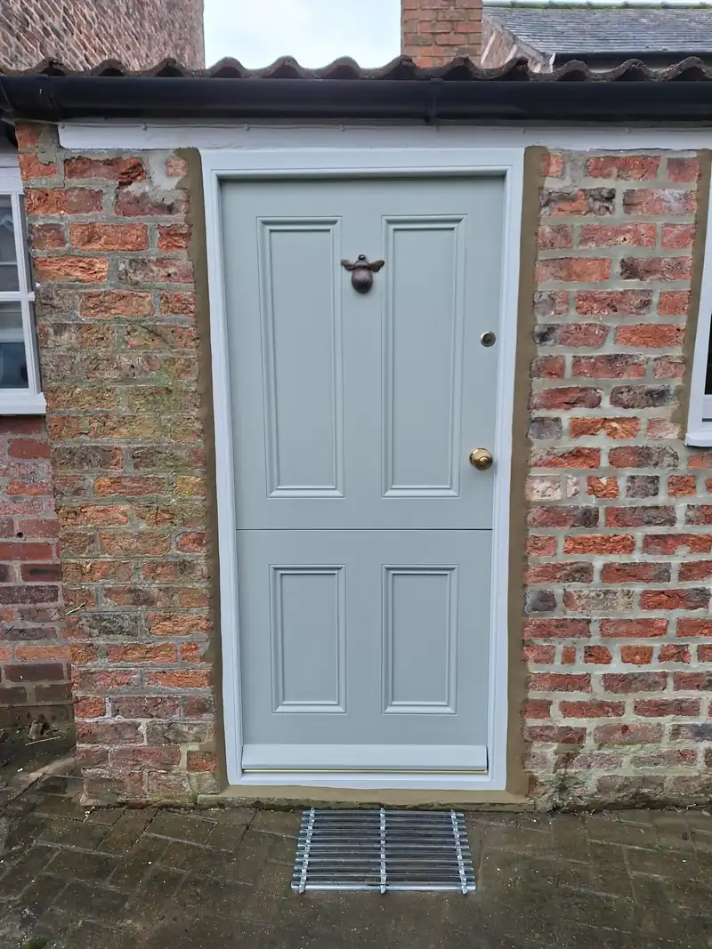 Painted front door in a brick cottage