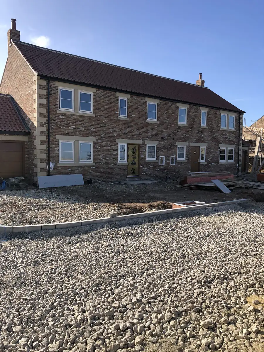 Pair of brick houses with stone quoins and sills