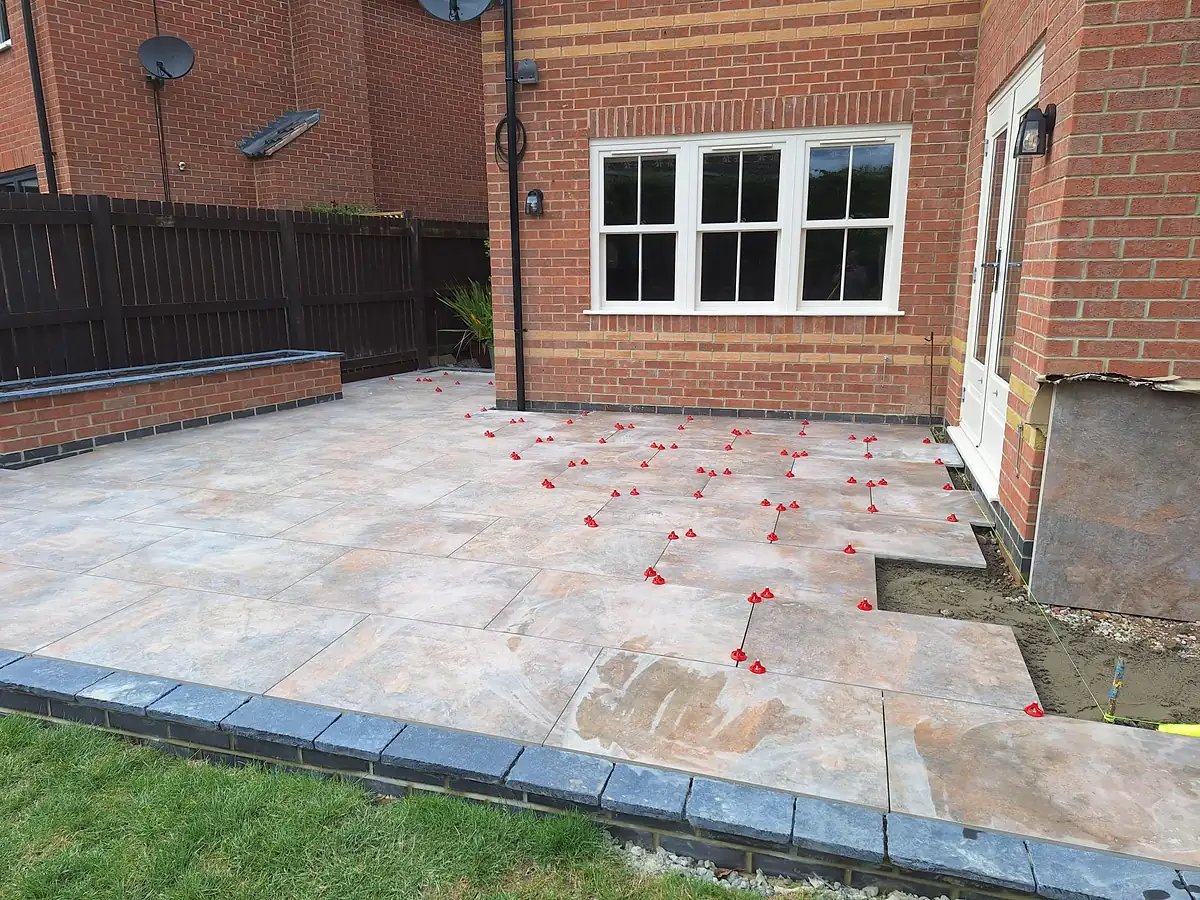 Porcelain patio at the back of a brick house