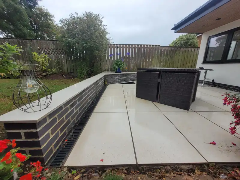 Porcelain patio beside a rendered extension