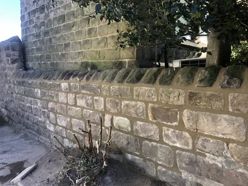 Rebuilt stone boundary wall