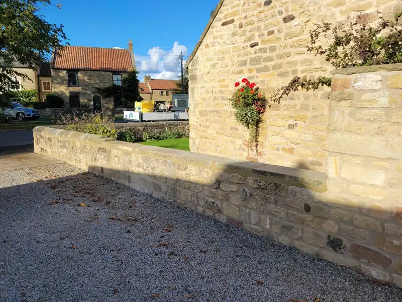 Rebuilt stone boundary wall