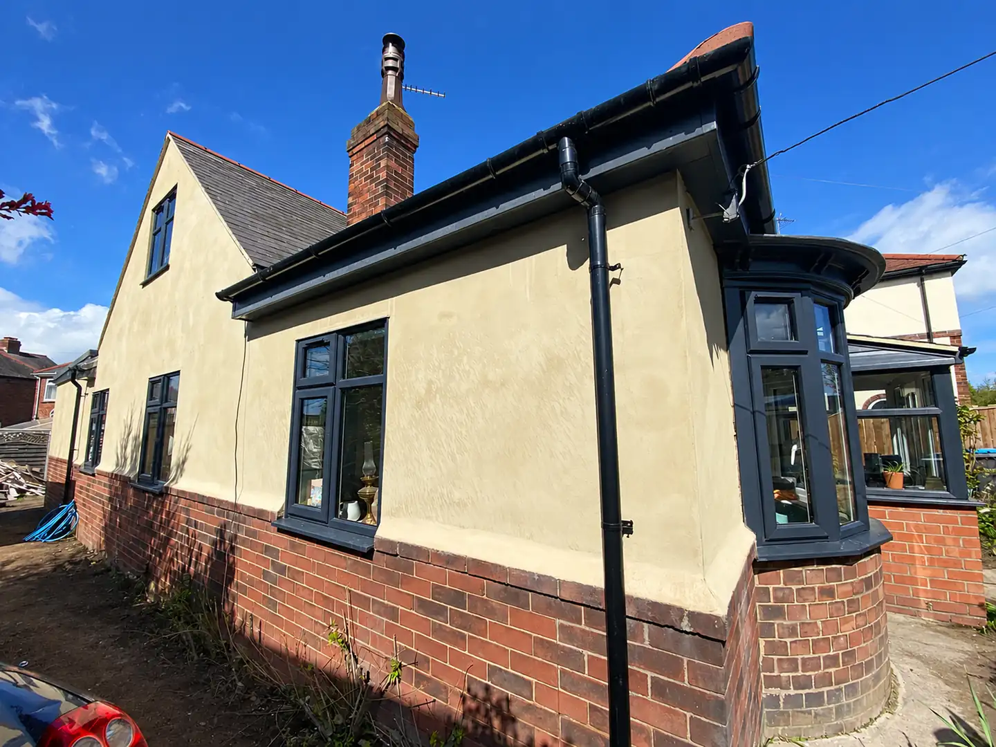 Rendered bungalow with a new extension and landscaping