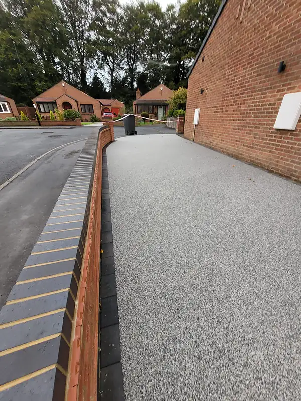 Resin driveway curving to a front door