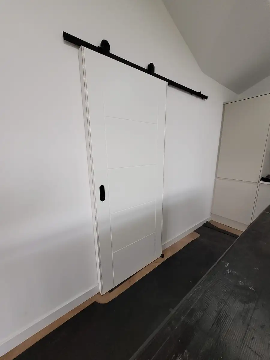 Sliding barn door on a black track