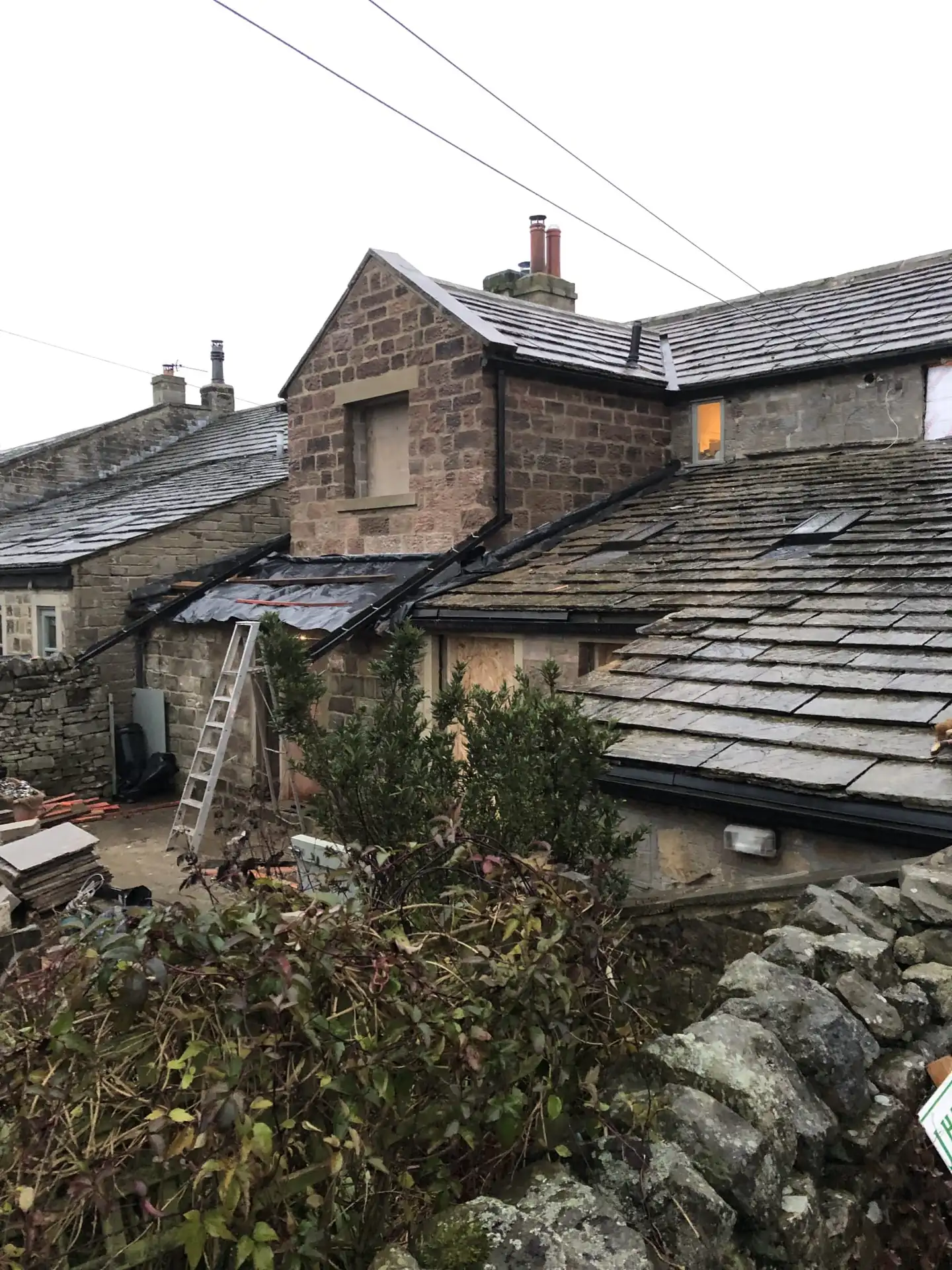 Stone cottage roof with slate and chimney