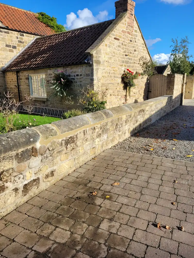 Stone cottage with a rebuilt garden wall
