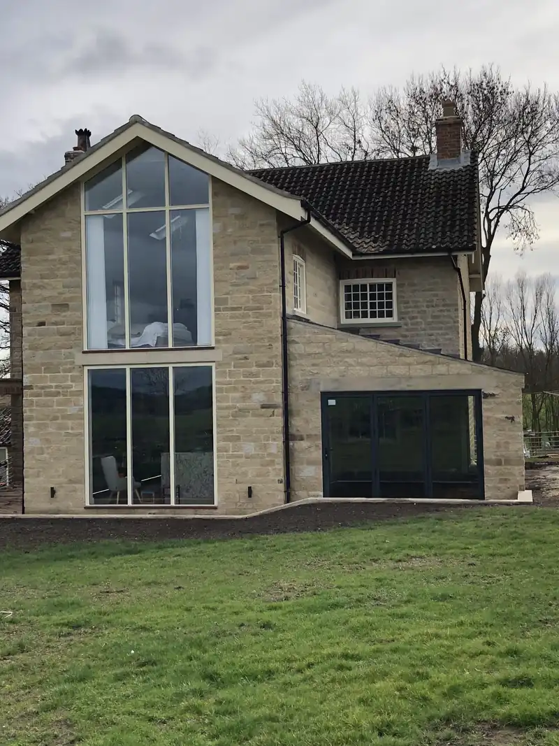 Stone extension with a full height glazed gable