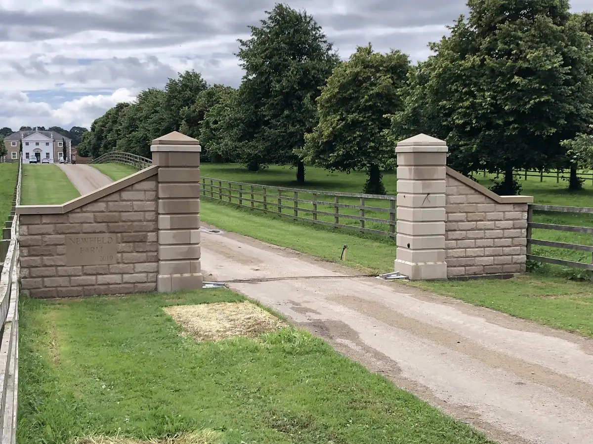 Stone gate piers with parkland beyond