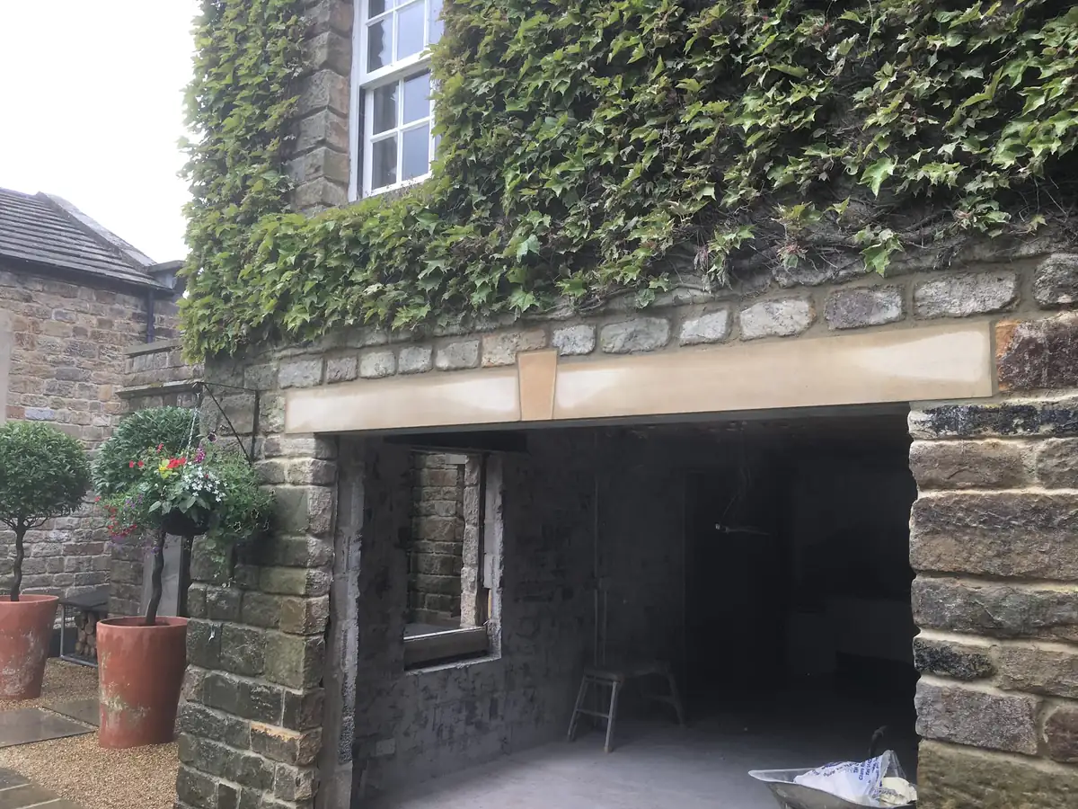 Old stone wall with a new opening formed