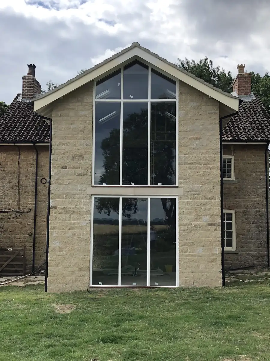 Tall glazed gable in stone