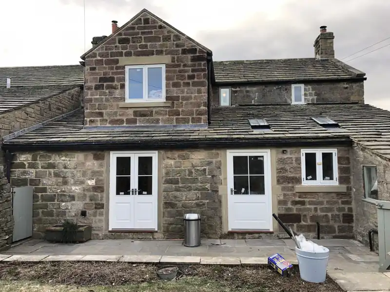 Two storey stone extension with French doors