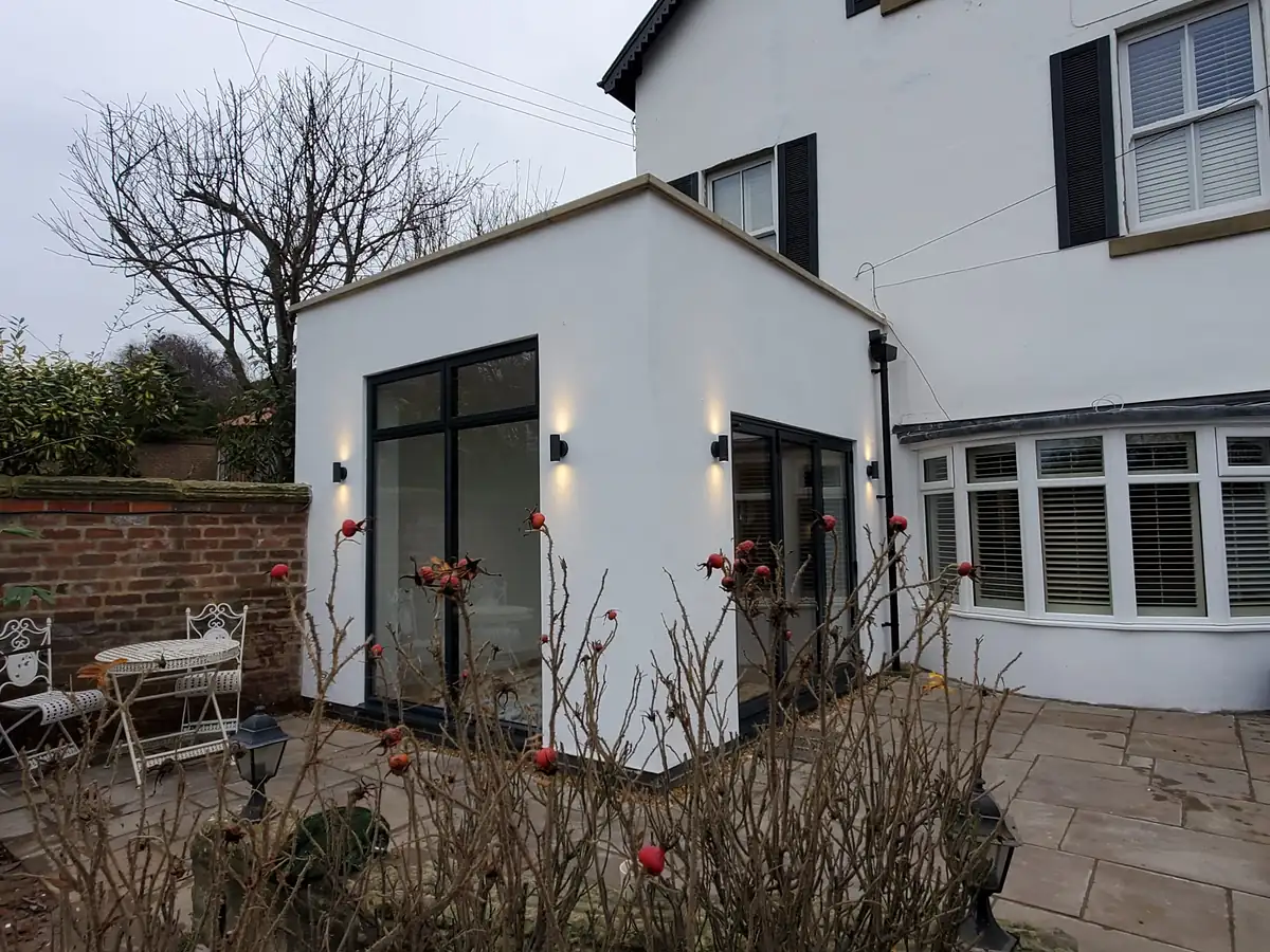White rendered extension with wall lights